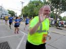 LARC member Steve Hines, N2PQJ, waves as he takes part in the 2018 Cow Harbor Run as part of the communication support team.